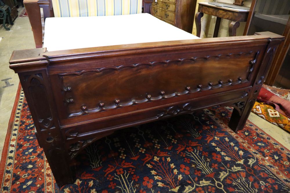 A William IV mahogany Gothic design bedstead, width 140cm